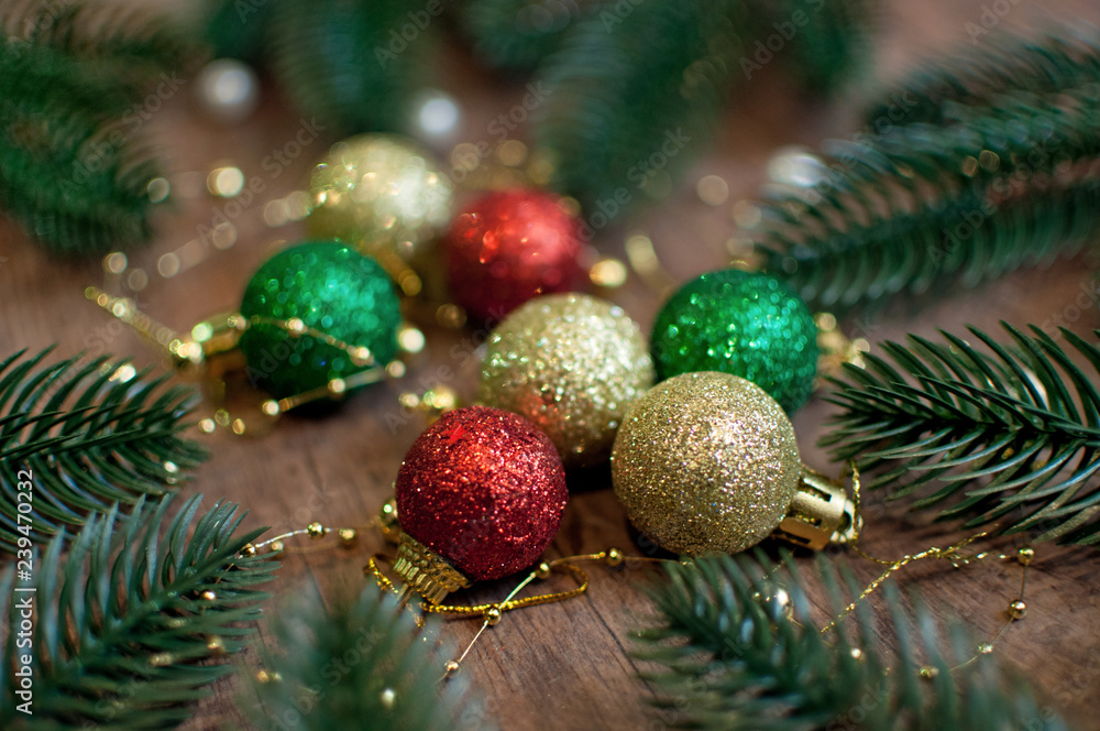 Christmas composition with golden, green and red Christmas balls decorated with fir three brunches, beads and pearls. Unfocused background
