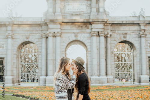 Couple women kissing on the street in Madrid city © karrastock