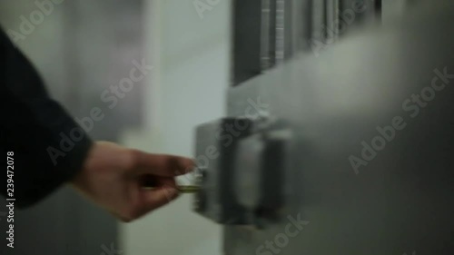 A guard opening a door inside a prison photo