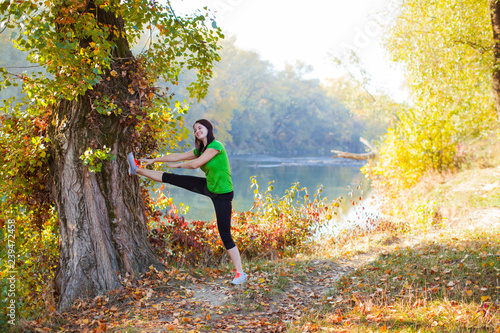 Portrait of young girl warming up before running