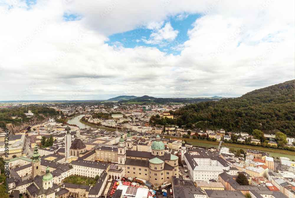 Salzburg city panorama with old town and Salzach river with great clouds above.