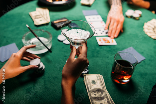 Canvas Print cropped image of woman and man playing poker table in casino, girl holding glass