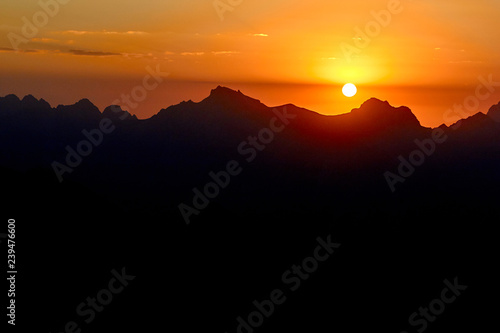 mountain silhouettes at the sunset, orange and red colors in the sky, Fann, Pamir Alay, Tajikistan