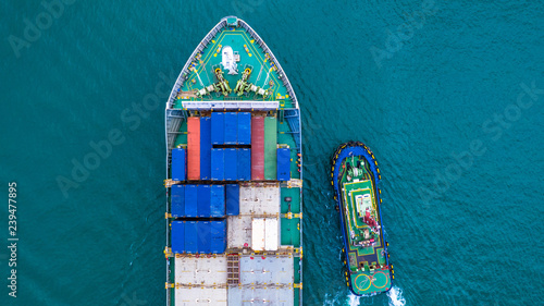 Container ship carrying container for import and export, Aerial view business logistic and transportation by ship in open sea.