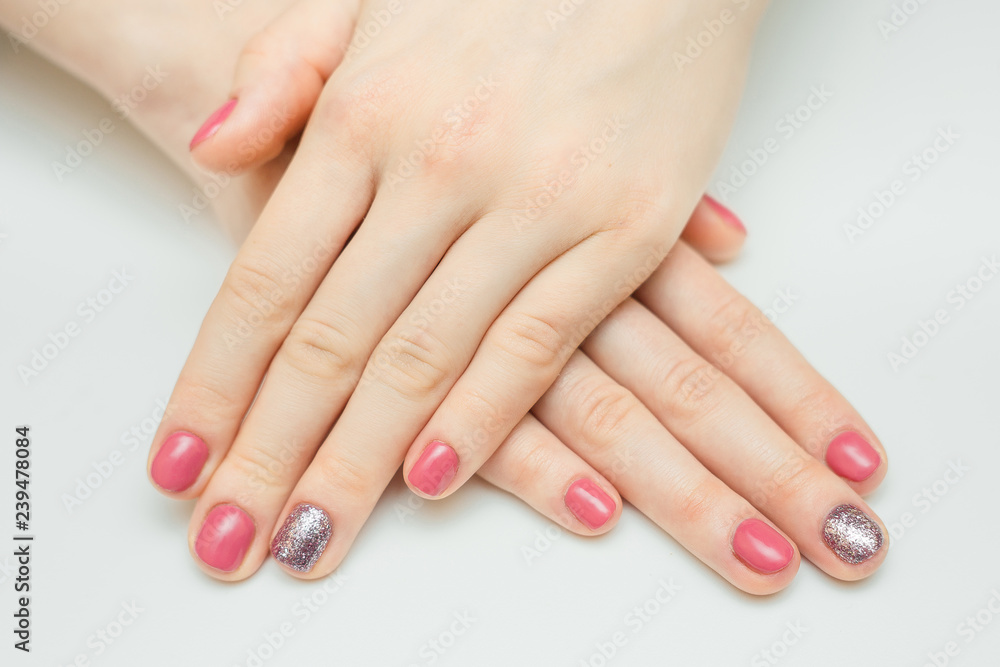 Hands with long artificial manicured nails colored with red nail polish Hands with long artificial manicured nails colored with red nail polish