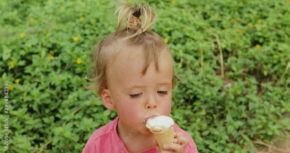 Cute Toddler boy Eating Ice-Cream. kid with dirty face eating ice cream Cute Toddler boy Eating Ice-Cream. kid with dirty face eating ice cream