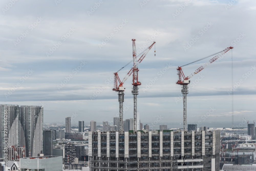 Construction cranes on a construction site in city Construction cranes on a construction site in city