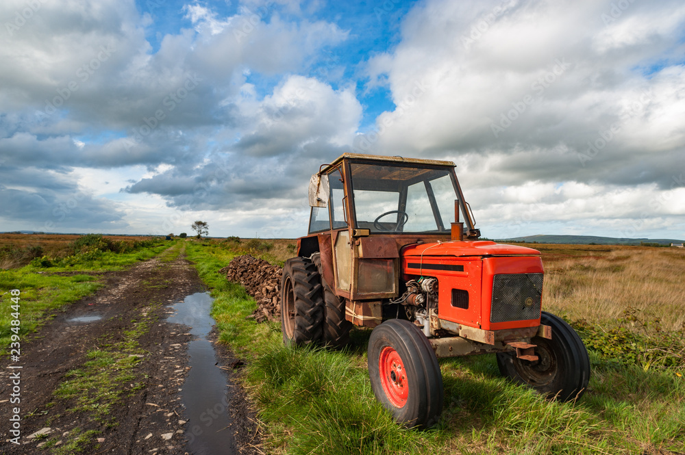 old rusty tractor in a peat bog landscape, rural Ireland old rusty tractor in a peat bog landscape, rural Ireland