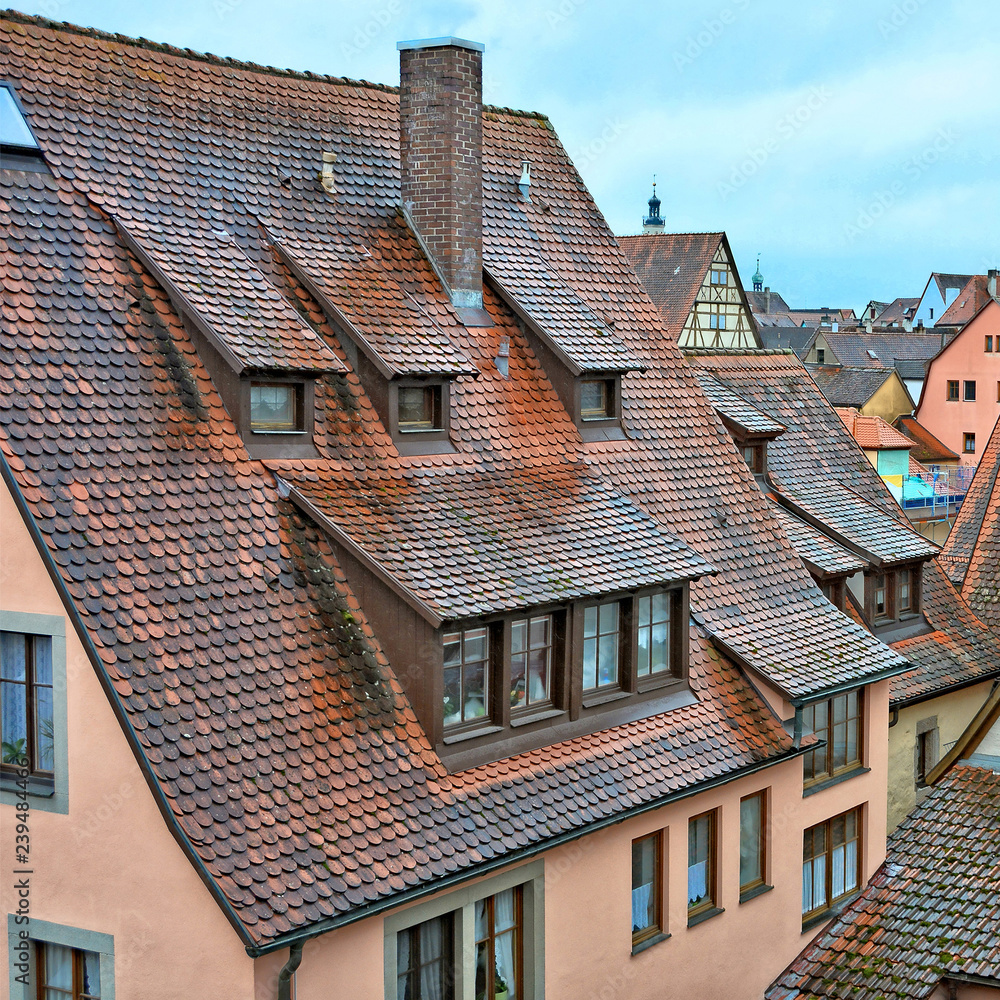 Old town. Red tile roofs of ancient houses. Beautiful attics. West Europe. European architecture.