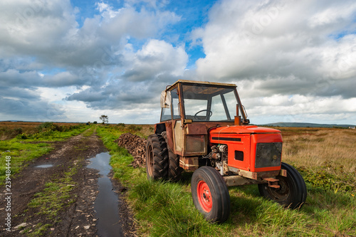 old rusty tractor in a peat bog landscape  rural Ireland 