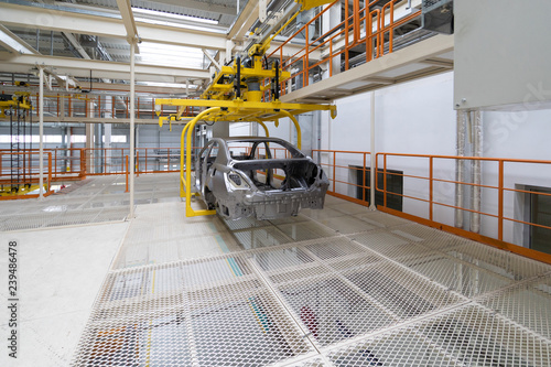 body of car on conveyor Modern Assembly of cars at plant. automated build process of the car body