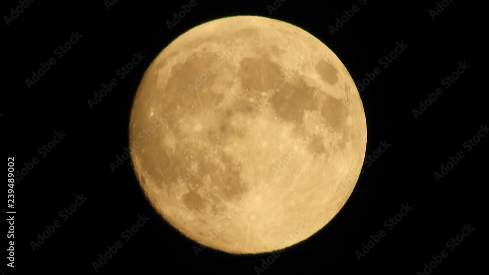 Moon with clouds moving on sky, 4k closeup video at night