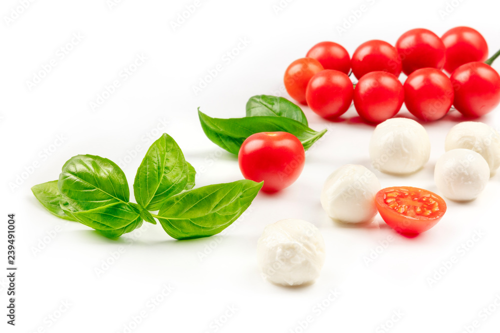 A photo of Mozzarella cheese balls with fresh basil leaves and cherry tomatoes, the ingredients of the Italian Caprese salad, on a white background with a place for text A photo of Mozzarella cheese balls with fresh basil leaves and cherry tomatoes, the ingredients of the Italian Caprese salad, on a white background with a place for text