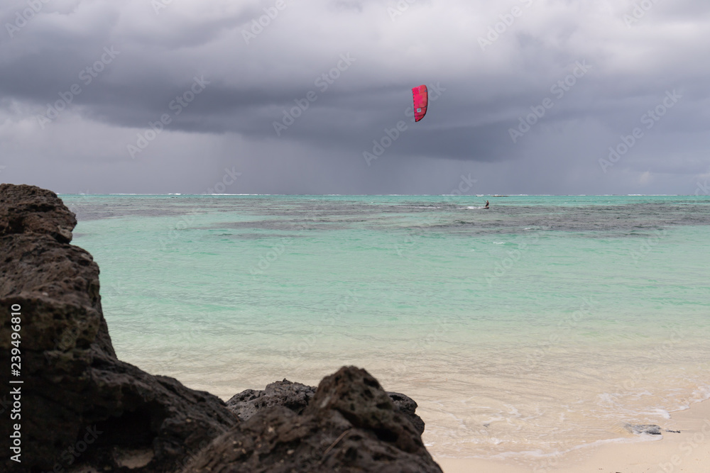 kitesurfer surfing in front of storm front kitesurfer surfing in front of storm front