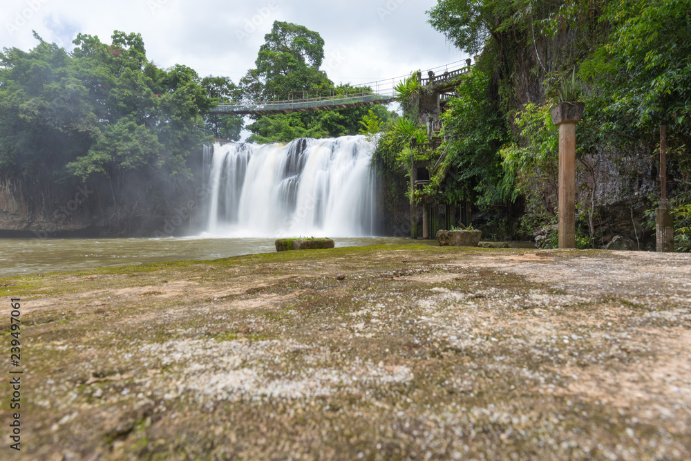 Obraz premium waterfall with hanging bridge