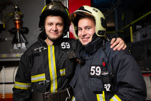 Photo of two firemen on background of fire truck © Sergey