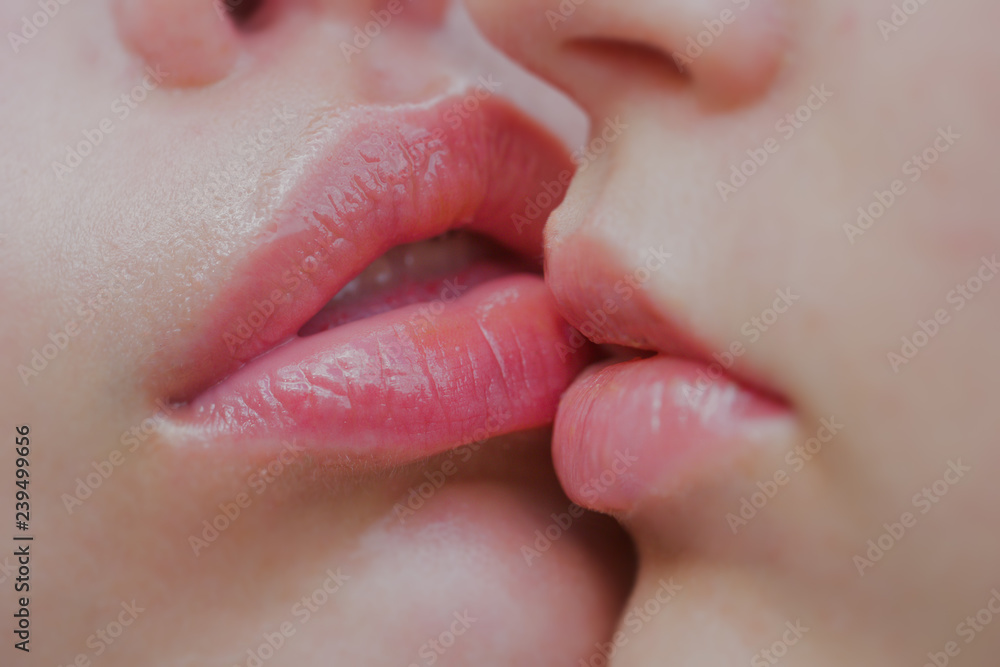 Lesbian couple kiss lips. Passion and sensual touch. Two beautiful sexy  lesbians in love. Lip Care And Beauty. Closeup of Beautiful Young Woman  Healthy Lips. Closeup of women mouths kissing. Stock Photo