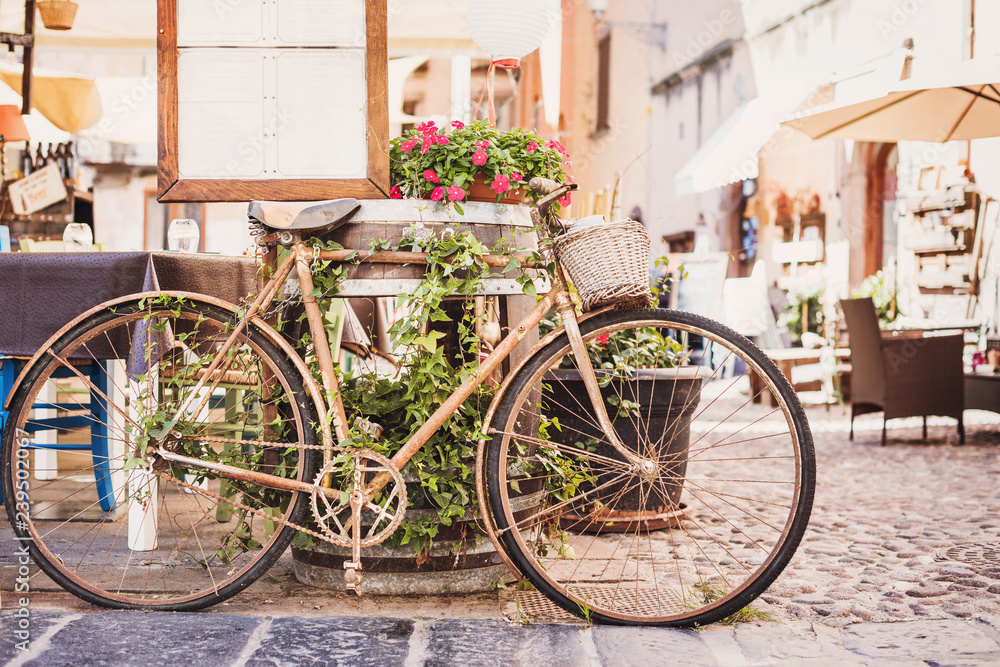 Old vintage retro bicycle with beautiful street at the background. Vacations in Europe. 