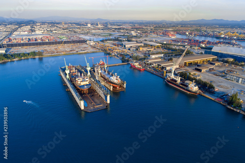 TOP VIEW, Aerial View of Industrial port with containers ship, business logistics concept, Aerial view from drone. © pengzphoto