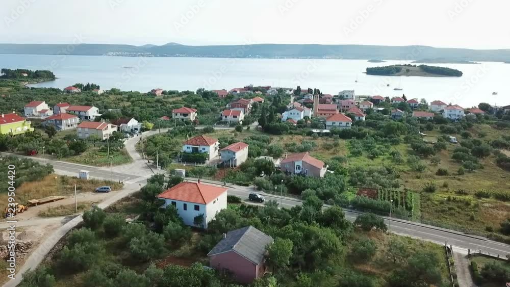 Aerial: Going over village Mrljane toward beautiful bay at Pasman island. Shot on vacation in Adriatic sea at Mediterranean coastline. Aerial: Going over village Mrljane toward beautiful bay at Pasman island. Shot on vacation in Adriatic sea at Mediterranean coastline.