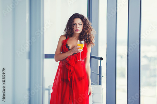 Free Download Curly woman drinking juice in red dress - GFXLoad
