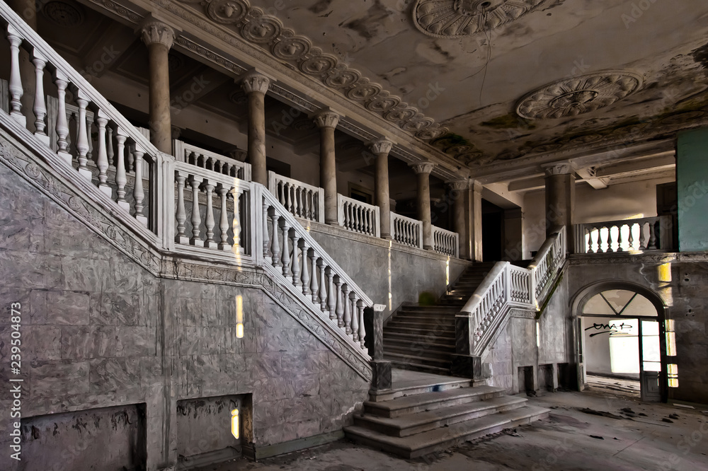 abandoned hall of a rich hotel with columns, the luxury of decline
