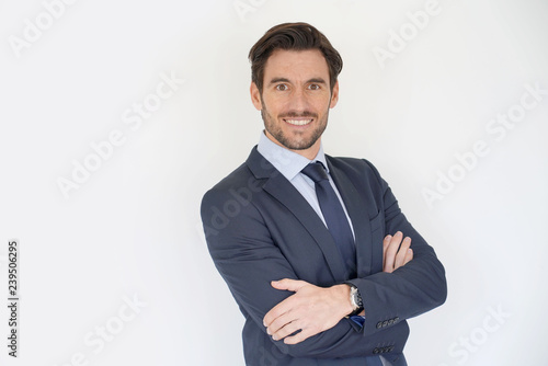 Isolated handsome businessman smiling in tailored suit