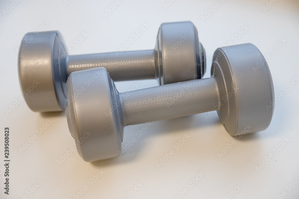 Grey dumbbells isolated with clipping path.Shaping and fitness equipment.Barbells in small size, close up. Healthy shape and sport concept.Physical therapy for the elderly Grey dumbbells isolated with clipping path.Shaping and fitness equipment.Barbells in small size, close up. Healthy shape and sport concept.Physical therapy for the elderly