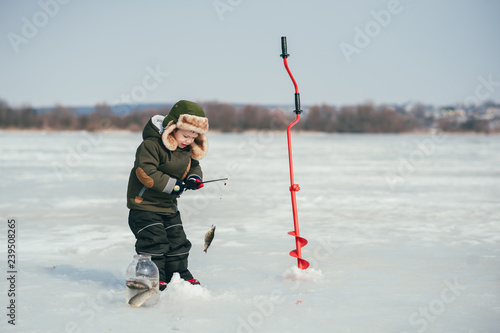 Obraz na plátne boy fishing on winter