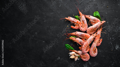 Large shrimp with lemon. Top view. Free space for your text. On the old background. photo