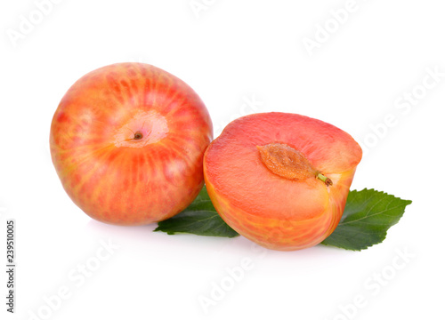 whole and half cut ripe fresh pluot on white background photo