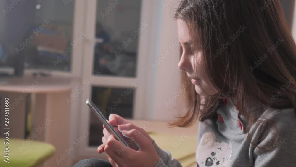 online shopping. little teen girl writes a message chatting in social media messenger. children technology and lifestyle communication concept. teenage girl with smartphone. girl playing online games online shopping. little teen girl writes a message chatting in social media messenger. children technology and lifestyle communication concept. teenage girl with smartphone. girl playing online games