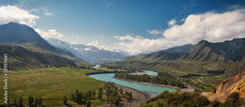 panorama of the summer landscape in the mountains. The valley of the mountain river Katun turquoise. the river flows between mountains and wide fields. blue sky and clouds view from high point