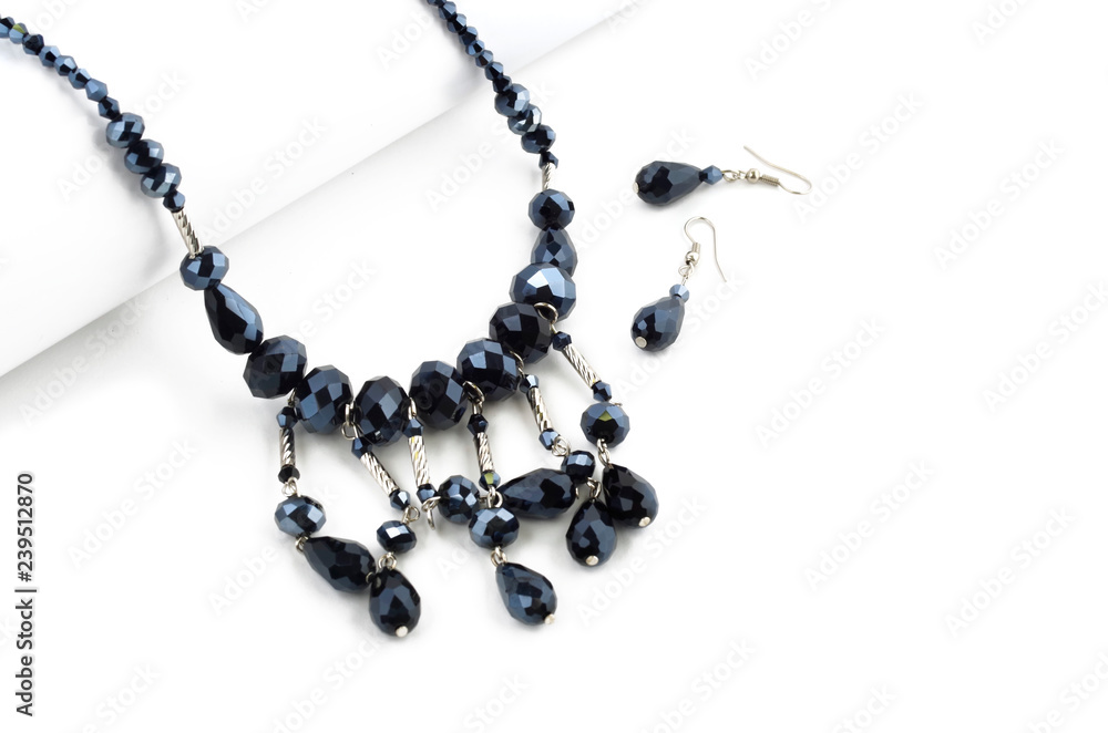 Faceted beads necklace with earrings on white background Faceted beads necklace with earrings on white background