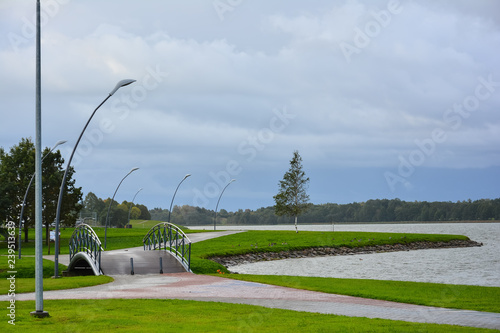 City embankment near the lake with equipped infrastructure for recreation.  Quay of Lake Mastis in Telsiai, Lithuania. photo