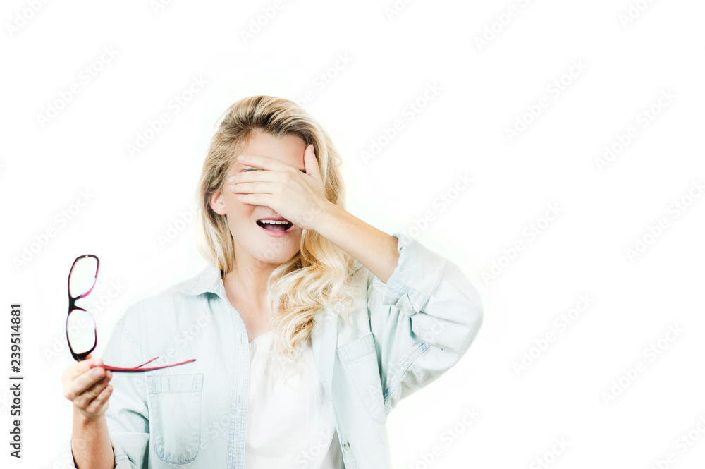 Young beautiful girl with broken glasses and lenses in the hands on isolated background. The concept of vision, health Young beautiful girl with broken glasses and lenses in the hands on isolated background. The concept of vision, health