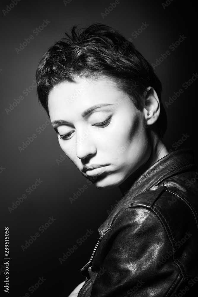 portrait of beautiful sensual woman looking down on dark background portrait of beautiful sensual woman looking down on dark background