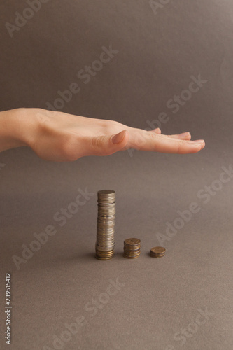 Hand on top of coins depicting the desire for growth. The concept of financial growth, accumulation of money.
