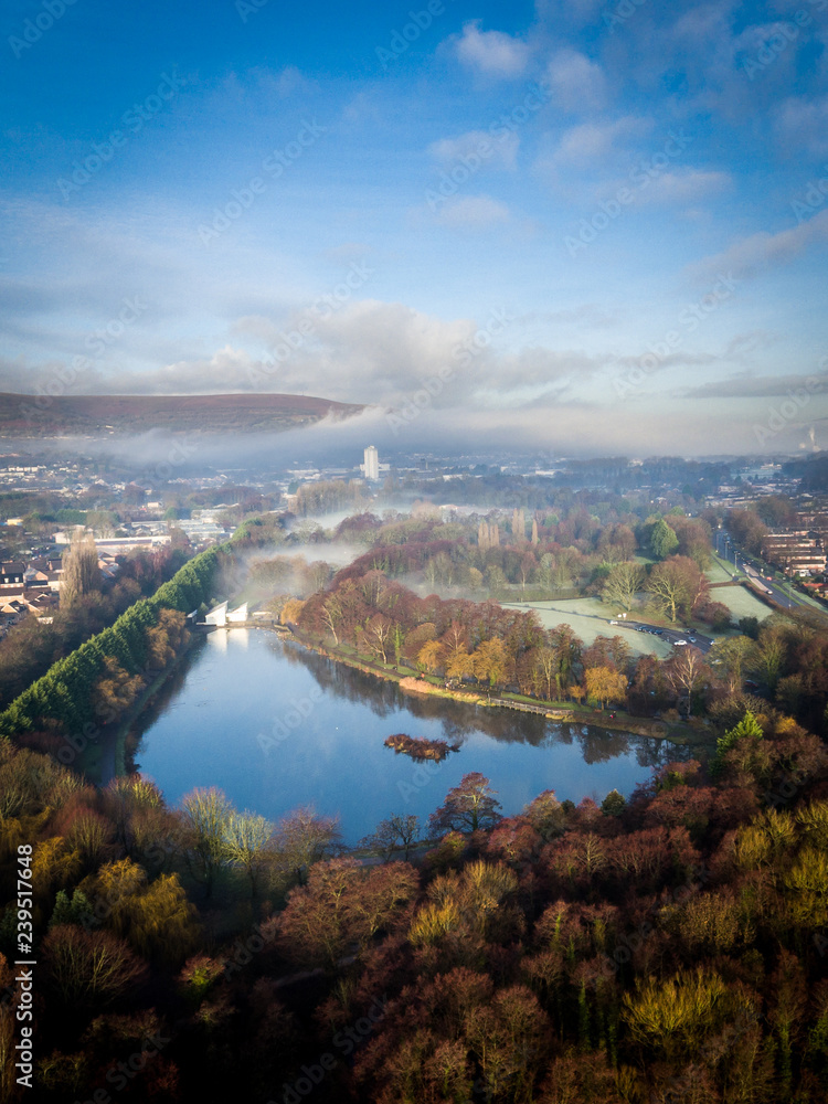 Aerial view of early morning fog and mist raising over Cwmbran, South Wales, UK