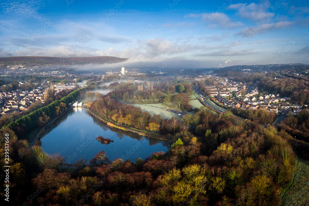 Aerial view of early morning fog and mist raising over Cwmbran, South Wales, UK