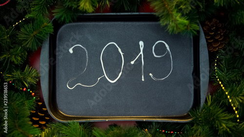 2019 year number written with cream on baking tray, preparation for holidays