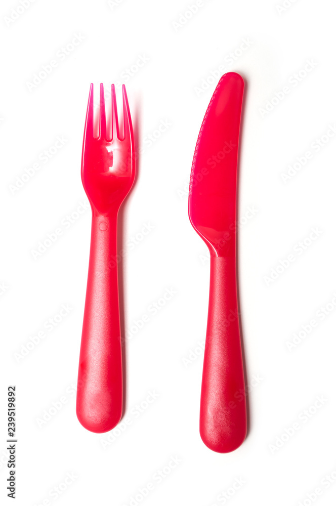 set of red baby plastic fork and knife on white background set of red baby plastic fork and knife on white background