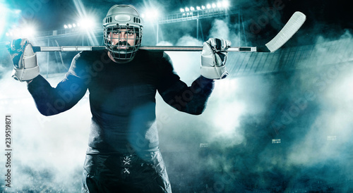Canvas Print Ice Hockey player in the helmet and gloves on stadium with stick.