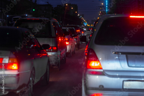 evening dense traffic of cars in the city in the winter in a small blur © Nady