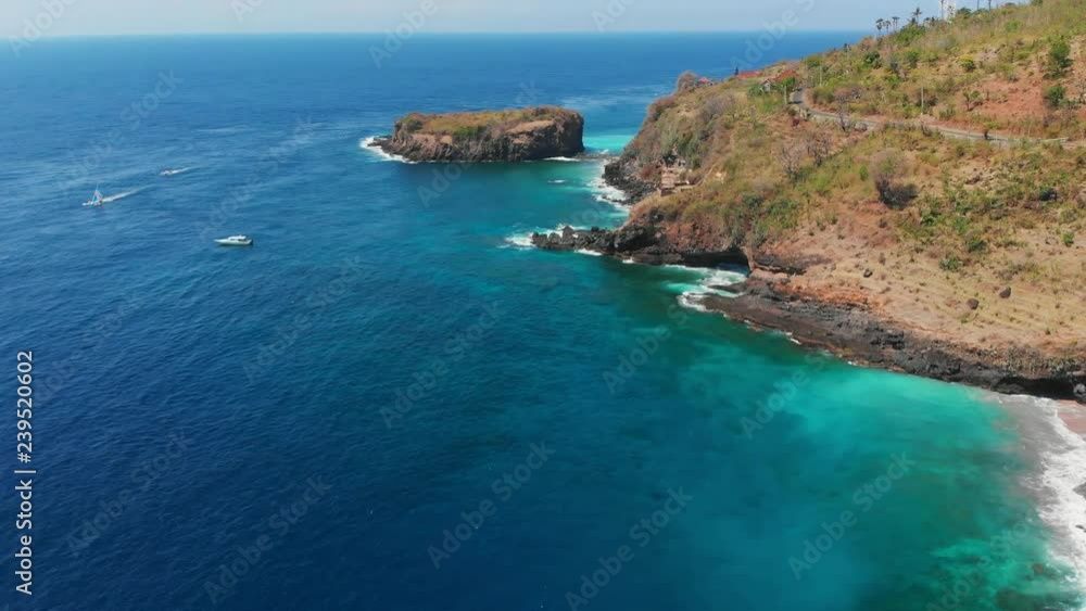 Aerial view of blue ocean, rocky island with stones Aerial view of blue ocean, rocky island with stones