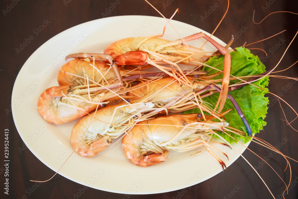 Steamed Seafood from sea market, Fresh Tasty Appetizing Cooked Tiger Prawns on Wooden Table Background. Food, Nutrition, Allergy, Aquatic food supply, Healthy Meal, Sea Beach and River Cuisine concept Steamed Seafood from sea market, Fresh Tasty Appetizing Cooked Tiger Prawns on Wooden Table Background. Food, Nutrition, Allergy, Aquatic food supply, Healthy Meal, Sea Beach and River Cuisine concept