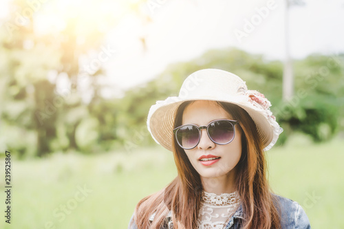 Young woman in a field , rounded sunglasses having fun outdoor in countryside.Awesome warm summer day.
