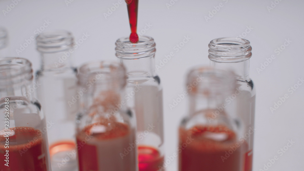 Pipette with drop of blood and test tubes Pipette with drop of blood and test tubes
