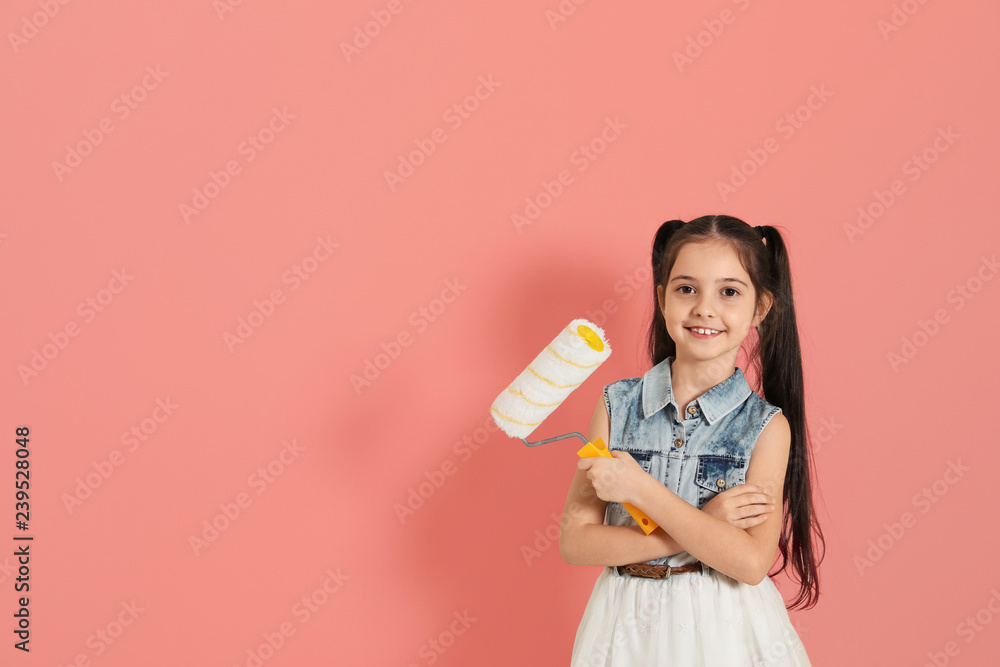 Child with roller brush on color background. Space for text Child with roller brush on color background. Space for text