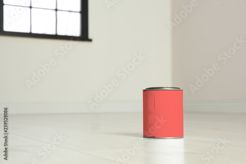 Can of living coral paint on floor indoors. Space for text